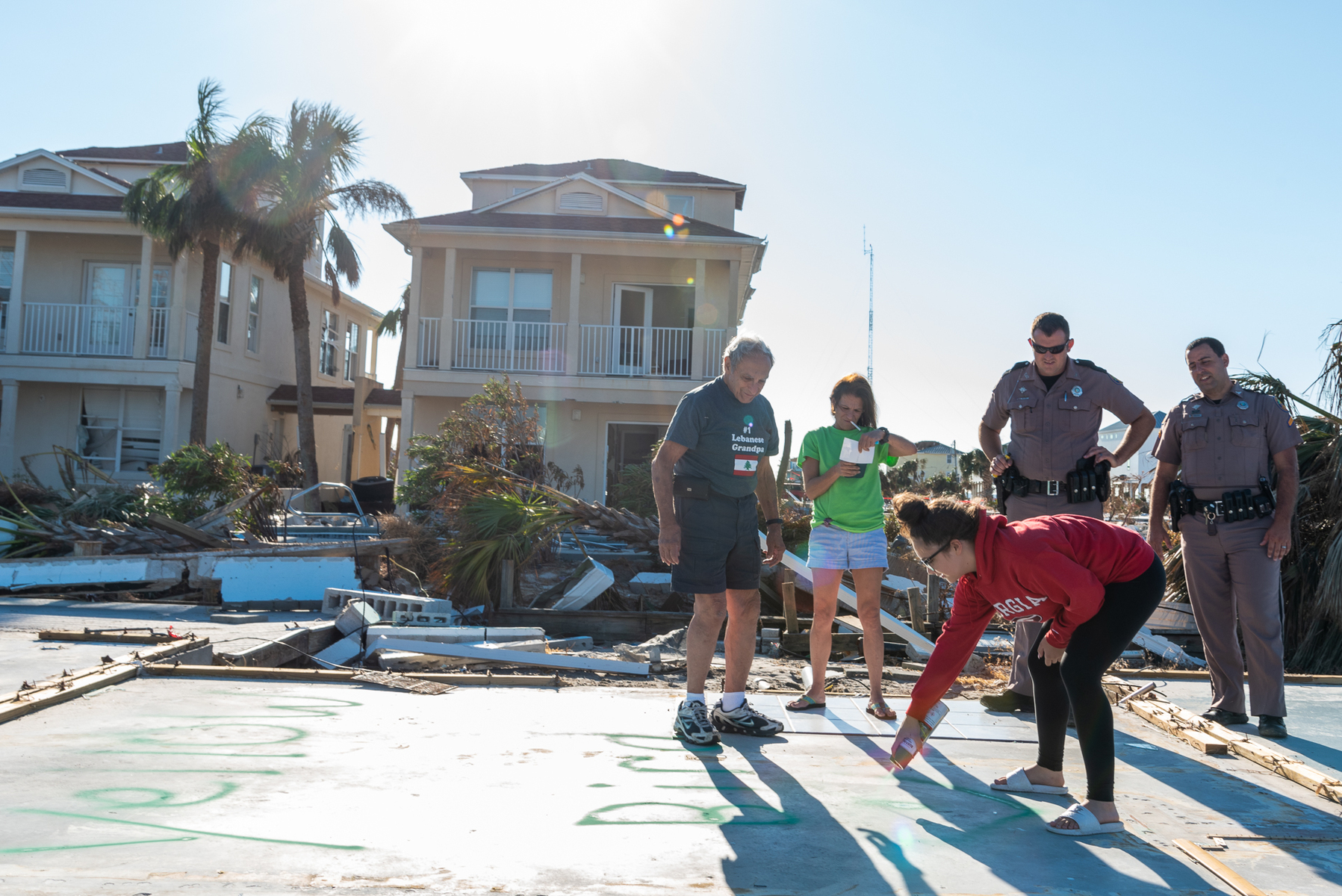October 18, 2018 - Mexico Beach, FL - George Mamary, daugther Adlette Eubanks and granddaughter Makalah of Atlanta, GA  survey what is left of their vacation home in Mexico Beach, Florida after Hurricane Michael as passed through the area on October 15, 2018 in Mexico Beach, Florida.  The hurricane hit the Florida Panhandle as a category 5 storm causing massive damage and claimed the lives of more then a dozen people.